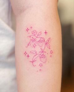 a woman's arm with a pink tattoo design on the left side of her body