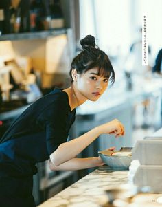 a woman is preparing food in a kitchen