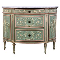 an ornately painted sideboard with marble top