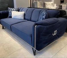 a blue couch sitting on top of a white floor