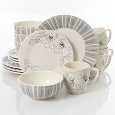 a white and gray dinner set with flowers on it