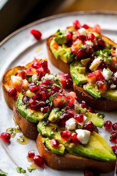 avocado toast topped with pomegranate and feta cheese