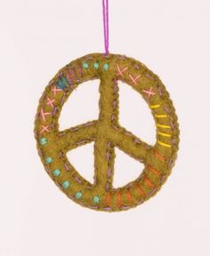 a peace sign ornament hanging from a string