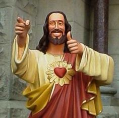 a statue of jesus giving the thumbs up