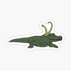 an alligator sticker with horns on it's head, sitting in front of a white