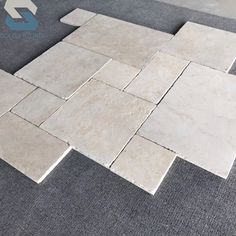 a tile floor that has been laid out on top of the carpet with an arrow pointing up