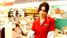 a woman standing in front of a store counter