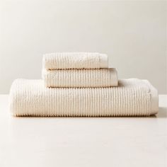 three white towels stacked on top of each other