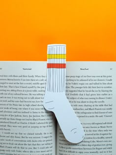 an open book with a piece of paper cut out of it's bottom part