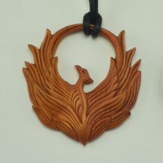 Hand Carved Sabo Wood Holy Phoenix Pendant With Adjustable Necklace Cord To Fit All Sizes. Approximately 1.7" Length By 1.5" Width. Return To Tiffany Necklace, Fantasy Pendant, Faux Gauges, Gold Leaf Pendant, Phoenix Necklace, Phoenix Pendant, Turquoise Statement Necklace, Wood Carving Designs, Septum Jewelry