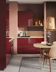 a modern kitchen with red cabinets and white counter tops, including a round dining table