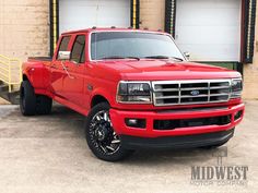 a red truck parked in front of a building