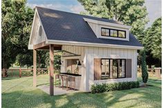 a small house with a covered porch and an outdoor kitchen area in the front yard