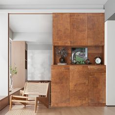 a living room with wooden furniture and white walls