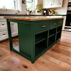 an island in the middle of a kitchen with lots of cupboards and drawers on it