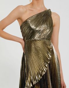 This stunning Pleated Metallic One Shoulder High Low Gown features a unique one shoulder neckline. The pleated metallic fabric adds a touch of glamour, while the high low ruffle hem adds a modern and chic twist. Perfect for any special occasion, this gown is sure to turn heads. Ieena for Mac Duggal Pleated metallic charmeuse fabric (100% polyester) One shoulder neckline Sleeveless High low ruffle hem Concealed back zipper Approx. 60" from top of shoulder to bottom hem Available in Gold Style #49 Gown Cocktail, Lame Dress, Gown Gold, High Low Gown, Gold Cocktail Dress, Bride Groom Dress, Western Chic, Daytime Dresses, Mac Duggal