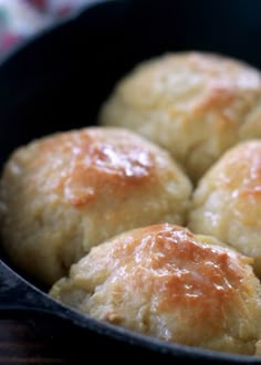 some bread rolls in a black pan on a table