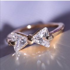 a diamond ring with two bows on it