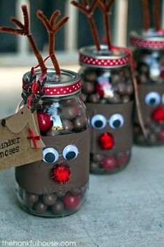 four mason jars with reindeer noses and candy in them, one has a tag on it