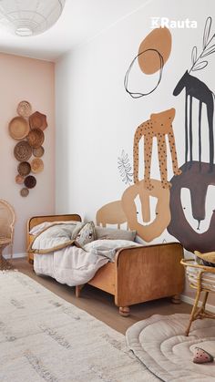 a child's room with a bed, chair and wall art on the walls