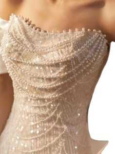 the back of a woman's dress with pearls on it