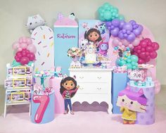 a birthday party set up with dora the explorer cake and balloons, toys and decorations