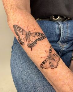 a person with a butterfly tattoo on their arm