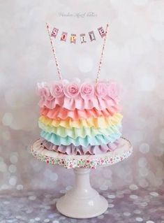 there is a cake that has been decorated with ruffles and flowers on it