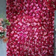 a large flower wall with pink and red flowers