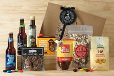 the beer and snacks hamper is packed with various types of food, including nuts