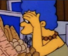 the simpsons character is holding her hand up to her face and looking at something in front of her