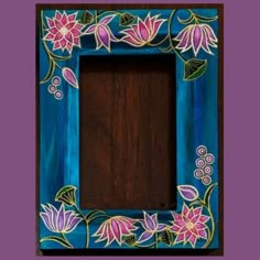 a blue frame with pink flowers painted on the front and bottom, sitting against a purple background