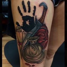 a woman's leg with a tattoo on it and an image of a hand print