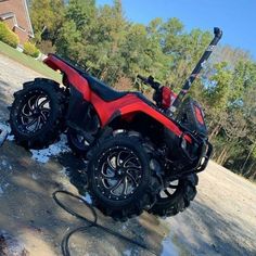 a red four wheeler parked in the snow