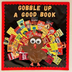 a bulletin board with a turkey made out of candy bar wrappers and the words gobble up a good book