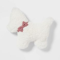 a white stuffed animal with a red striped bow