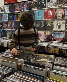 a man standing in front of a display of cds