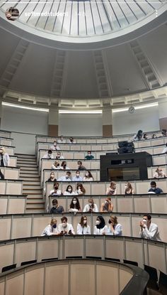 many people are sitting in the middle of a lecture hall