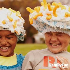 two young boys wearing hats with doughnuts on top of them, smiling at the camera