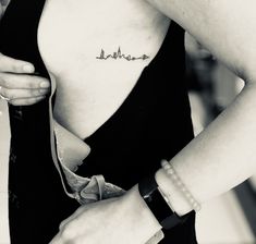 black and white photograph of a woman's chest with the word love written on it