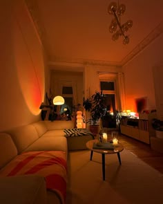 a living room filled with furniture and candles