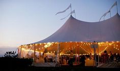 a large white tent with lights on it