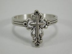 This is a bold, hand-crafted Sterling Silver Cross Ring. High polished solid 925 sterling silver ring of great quality. Its intricate design creates a very unique look! Makes a beautiful ring for your loved one.   Ring will arrive in a nice fitted jewelry box.   Face height  is 17mm x 12mm wide (cross design size) Band is 3mm wide x 1.2mm thick For a slightly larger ring with the same design click this link. https://www.etsy.com/your/shops/MillraceLaneBoutique/tools/listings/stats:true/472130362 Silver Engraved Cross Ring, Silver Cross Ring With Polished Finish, Silver Cross Rings Stamped 925, Vintage Sterling Silver Cross Ring, Vintage Cross Ring As Gift, Vintage Cross Ring For Gift, Vintage Silver Cross Ring, Sterling Silver Cross Ring Symbolic Style, Symbolic Sterling Silver Cross Rings