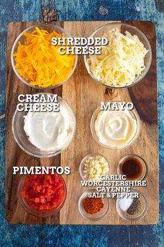 the ingredients for cheese dip on a cutting board