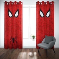 a spiderman themed window curtain in a room with a chair and potted plant