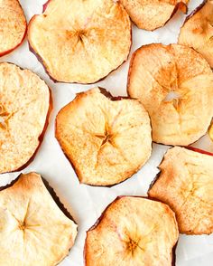 several pieces of apple sitting on top of white paper