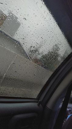 the inside of a car with raindrops on it