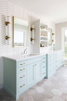 a large bathroom with two sinks and mirrors