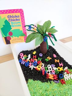 a child's birthday cake decorated with letters and a tree