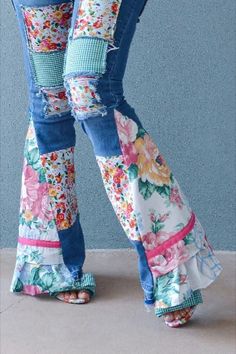 the legs of a woman in high heeled jeans with floral print and ruffled hems